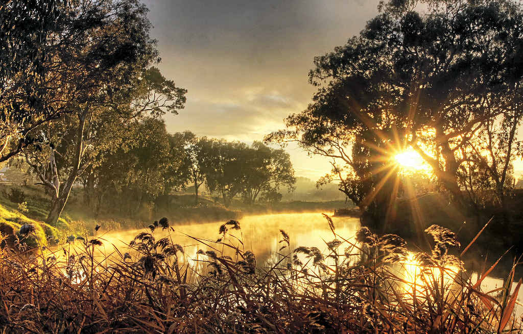 BEAUTIFUL MORNING: Local weather photographer Chris McFerran snapped this shot of the sun rising over the Condamine River on a warmer-than-average morning on Thursday.